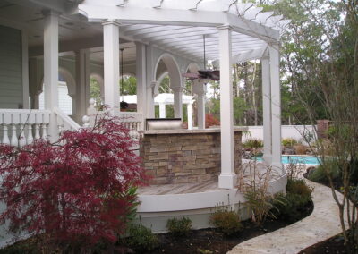 outdoor kitchen on back porch with built-in grill