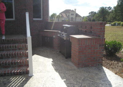 outdoor kitchen on back porch with built-in grill after