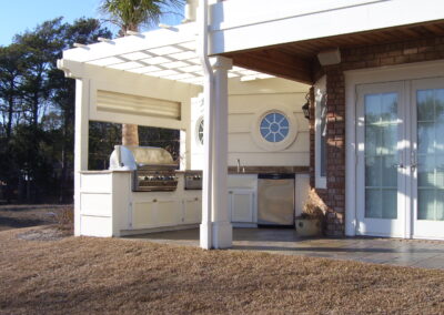 outdoor kitchen on back porch with built-in grill after