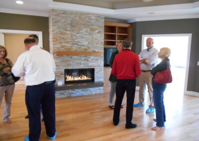 new gas fireplace in living room with stone surround