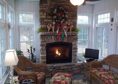 new gas fireplace in living room with stone surround