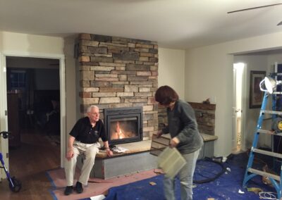 new gas fireplace in living room with stone surround