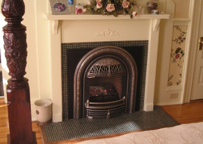 new gas fireplace in living room with white wood surround and mantel