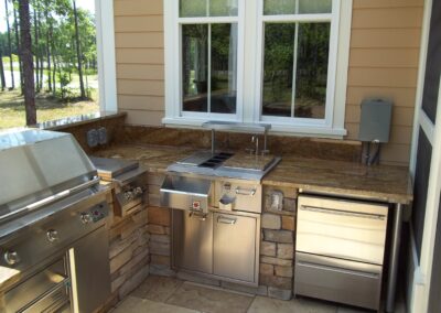 outdoor kitchen on back porch with built-in grill