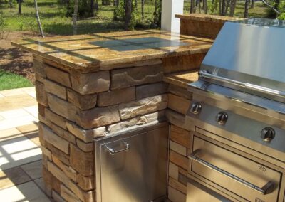 outdoor kitchen on back porch with built-in grill