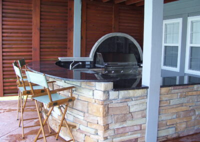 outdoor kitchen on back porch with built-in grill