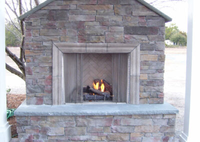 outdoor fireplace with light stone surround
