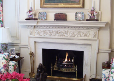 white marble surround around gas fireplace