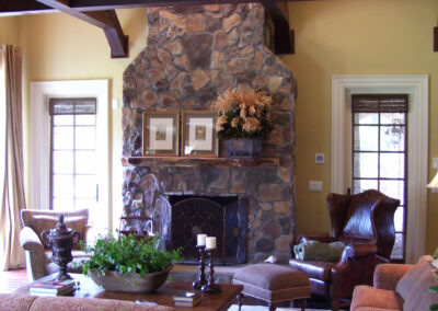 wood-burning fireplace with stone surround and wood mantel