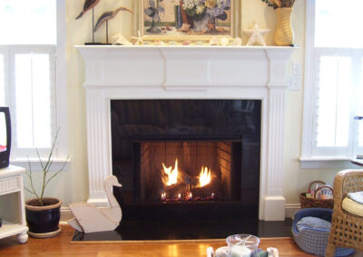gas fireplace with metal and white wood surround